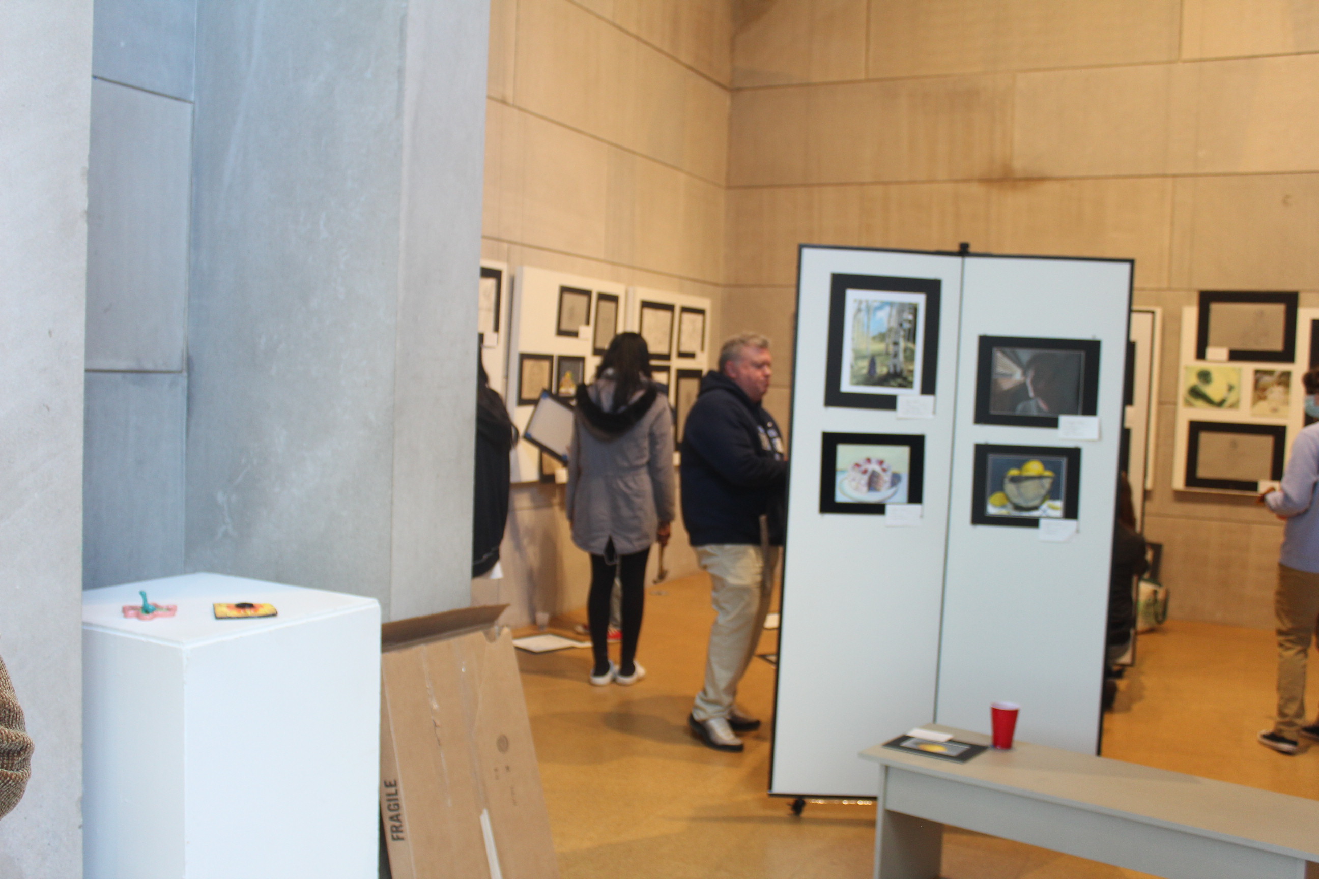 Visitors take in the student art work at the gallery's art show